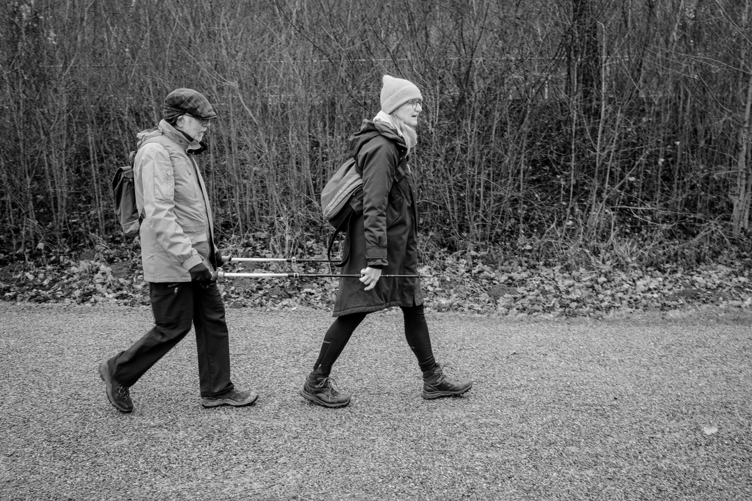 Angehörige begleitet älteren Menschen mit Demenz beim Spaziergang – Unterstützung und Nähe im Alltag