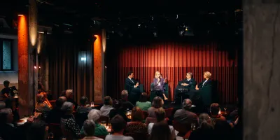 Blick auf die Podiumsdiskussion der Veranstaltung Mit Demenz leben, die Familie im Fokus: Auf der Bühne sitzen Moderator Maximilian Maier, Désirée von Bohlen und Halbach, PD Dr. Jens Benninghoff sowie Stefanie Wagner-Fuhs. 